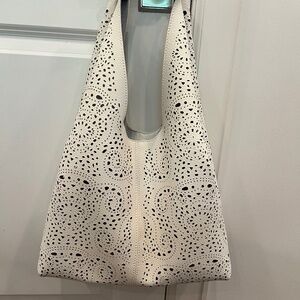 White hobo style bag with laser cut outs